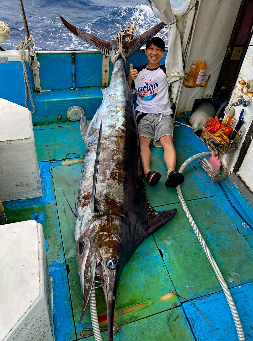 沖縄のトローリングでカジキを釣り上げた男性