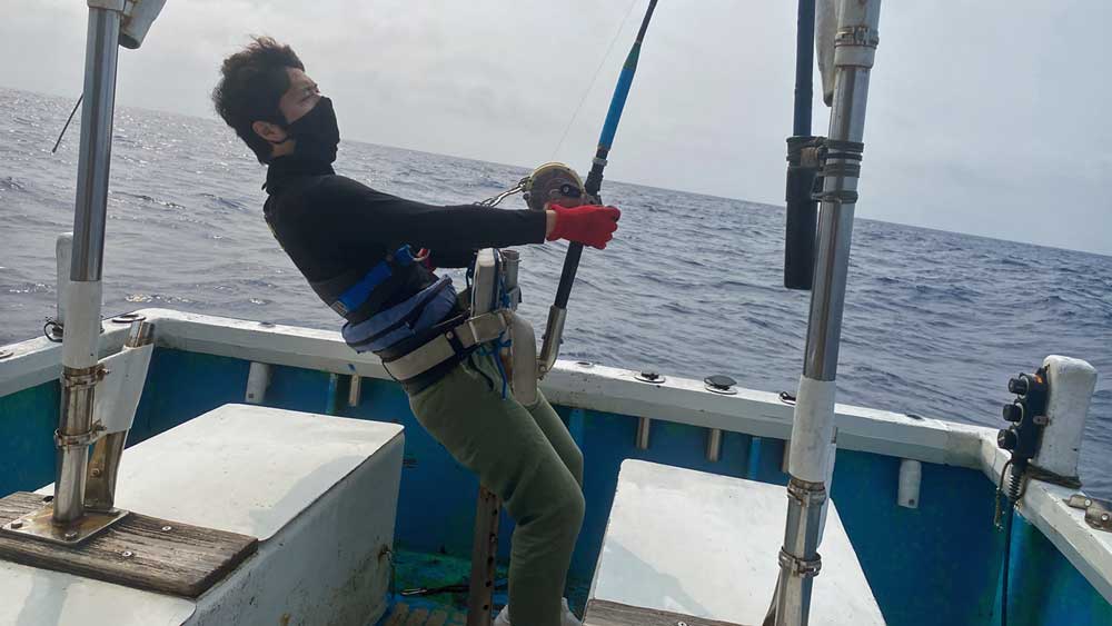 沖縄でカジキ釣りをしている男