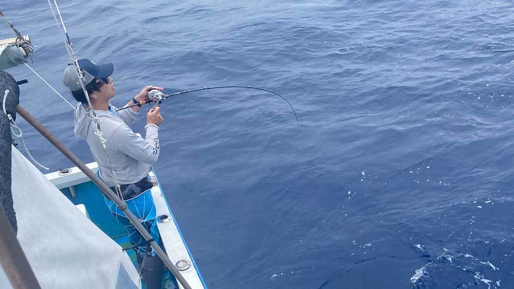 沖縄のジギングでカンパチ釣りをしている男性
