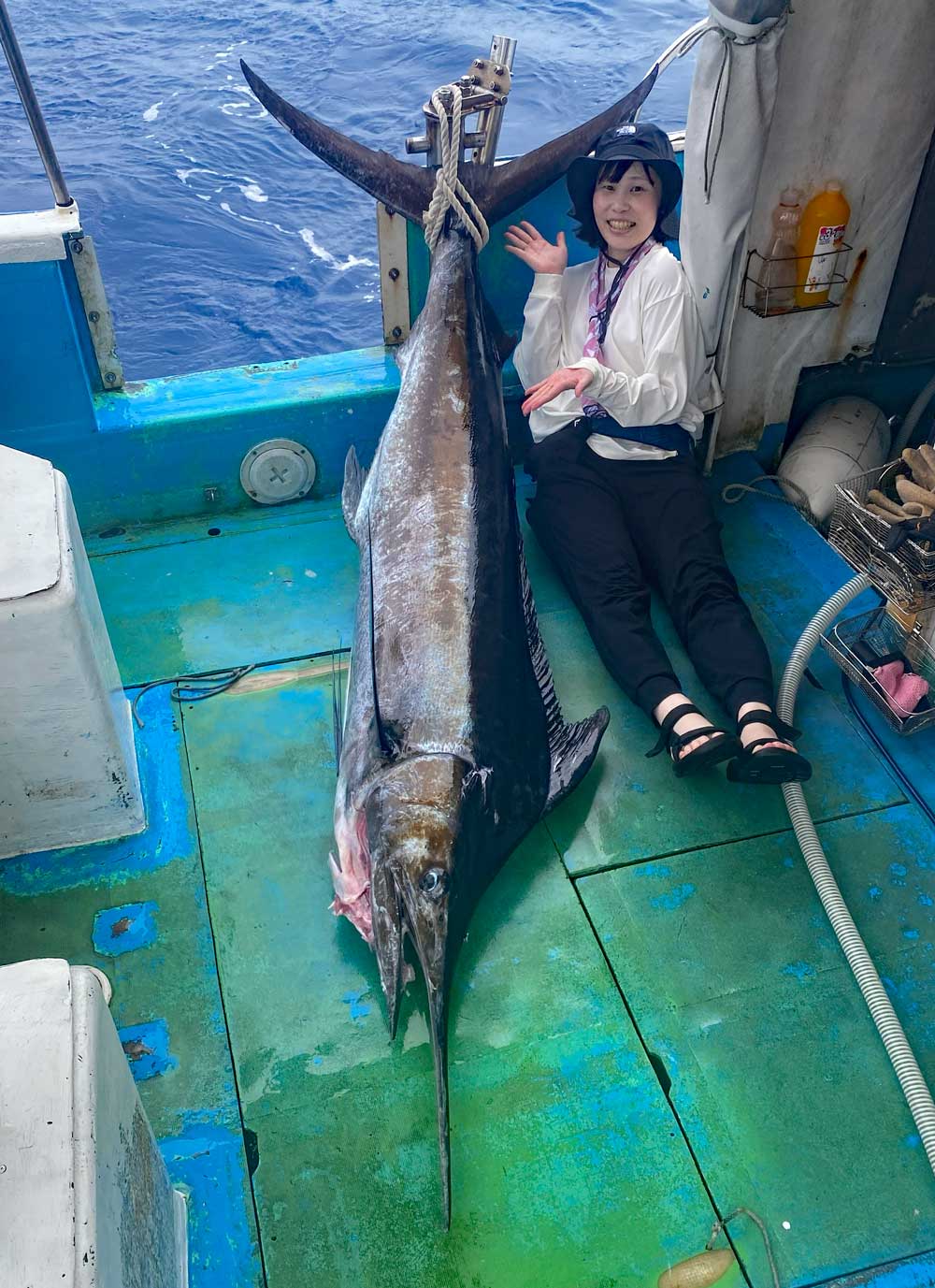 釣り上げたカジキと女性アングラー